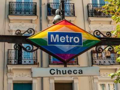 Entrance of the metro station in the Chueca neighborhood of Madrid in awe with the colors of the lgtb rainbow flag